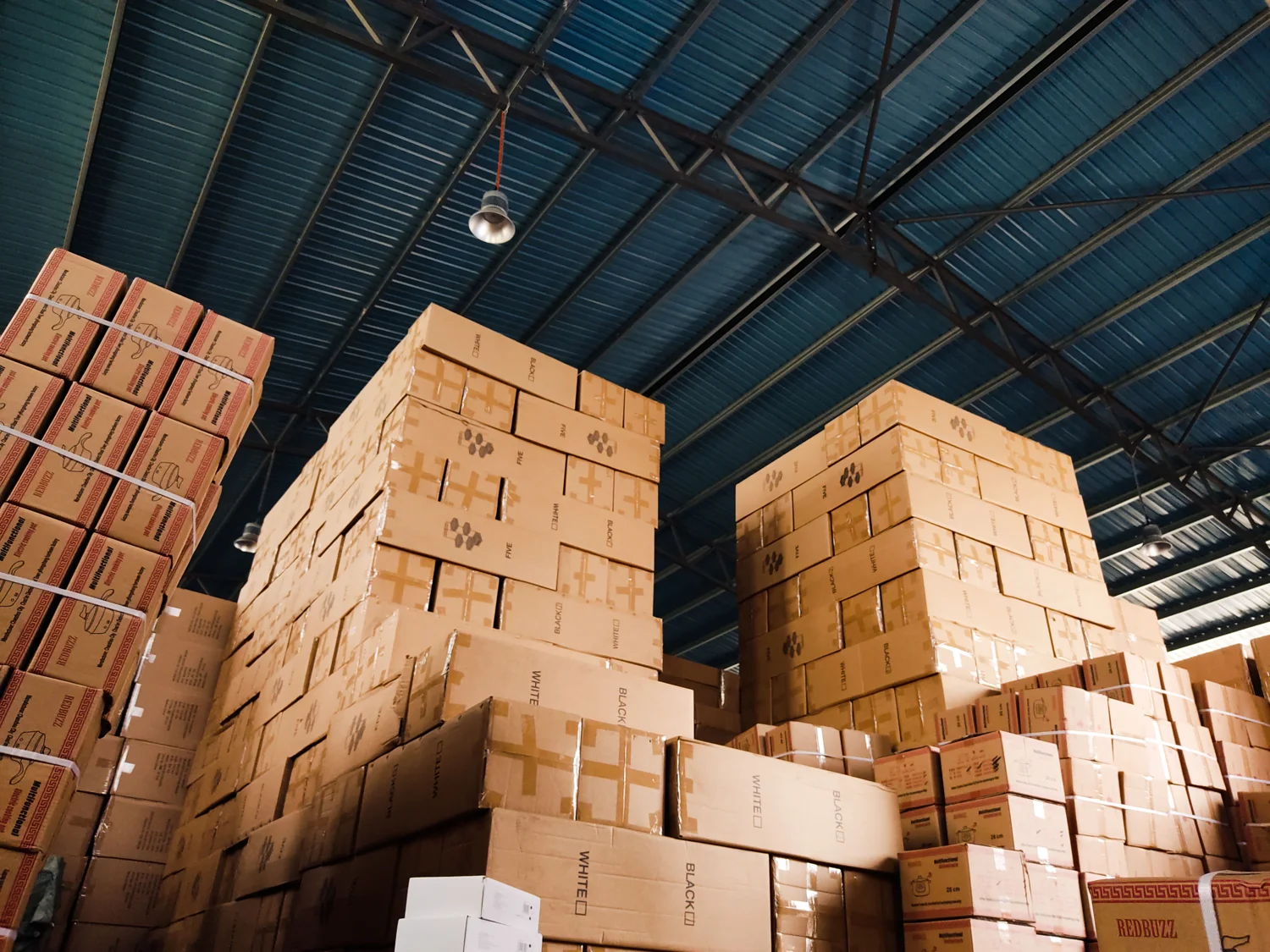 Packed cardboard cartons stacked inside a warehouse
